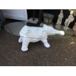 A fibreglass elephant coffee table with glass top