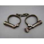 vintage pair of handcuffs with key