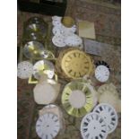 A quantity of clock faces, accessories and parts