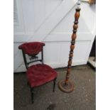 Upholstered mahogany chair and turned wooden floor lamp
