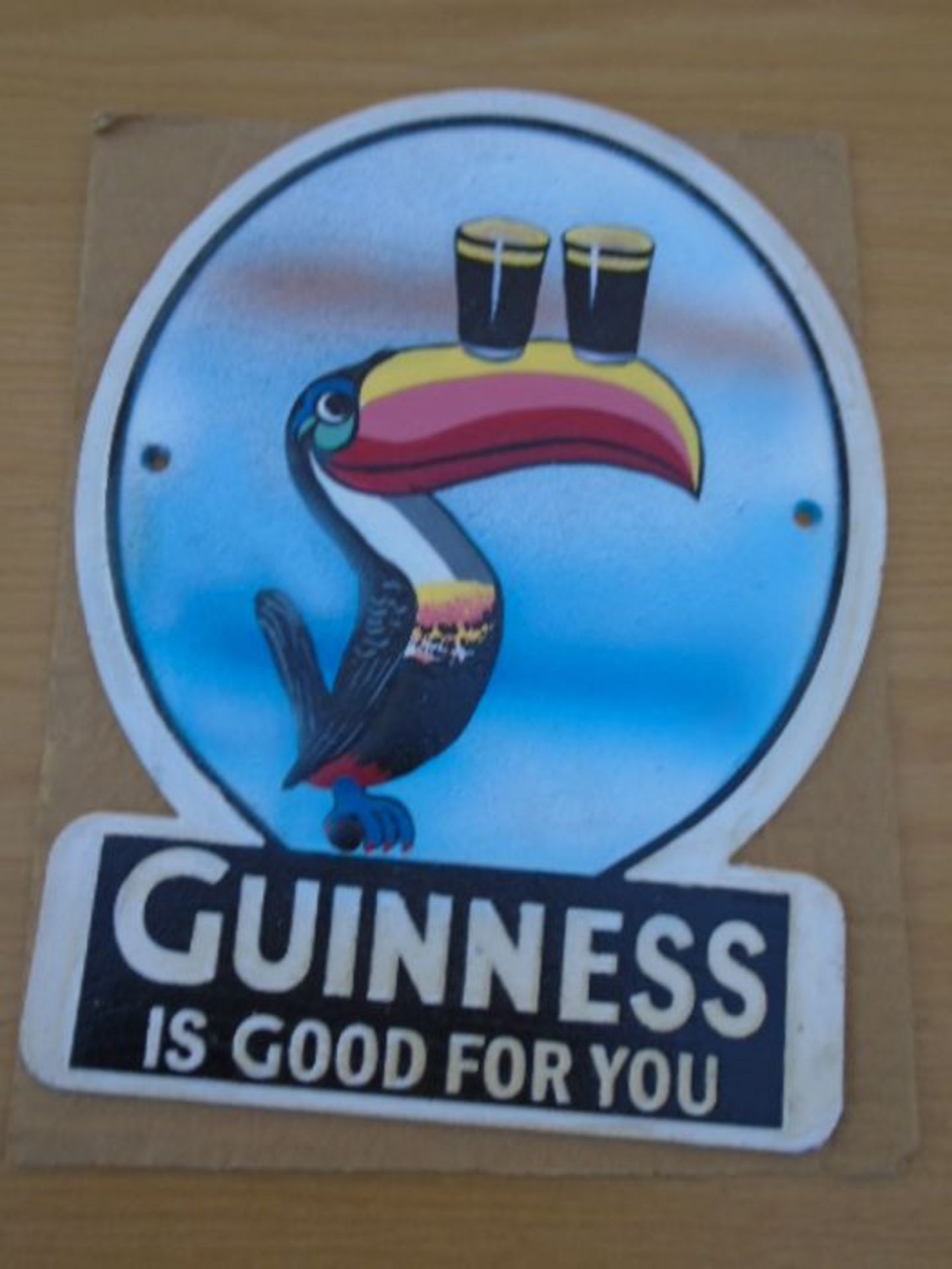 round Guiness toucan sign