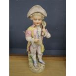 A bisque porcelain figurine of a boy 42cm tall