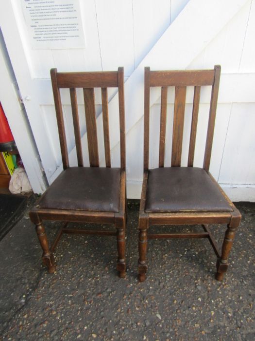 2 oak chairs with vinyl seats