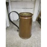 A large copper jug with brass lid