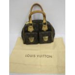 A Louis Vuitton Manhattan handbag with dust bag. some signs or wear on the base
