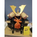 A Samurai helmet in a presentation box with accessories