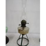 A glass oil lamp with legged base