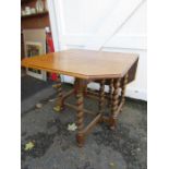 An oak gateleg table with barley twist legs