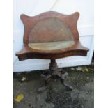 A vintage pedestal folding games table with carved detail to legs