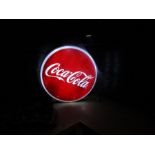 An LED light up Coca-Cola sign with wall fixings