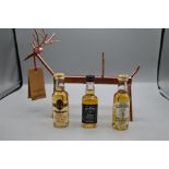 Lot to include 3 whisky miniatures and a festive reindeer bottle holder