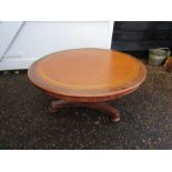 Round mahogany coffee table with vinyl top