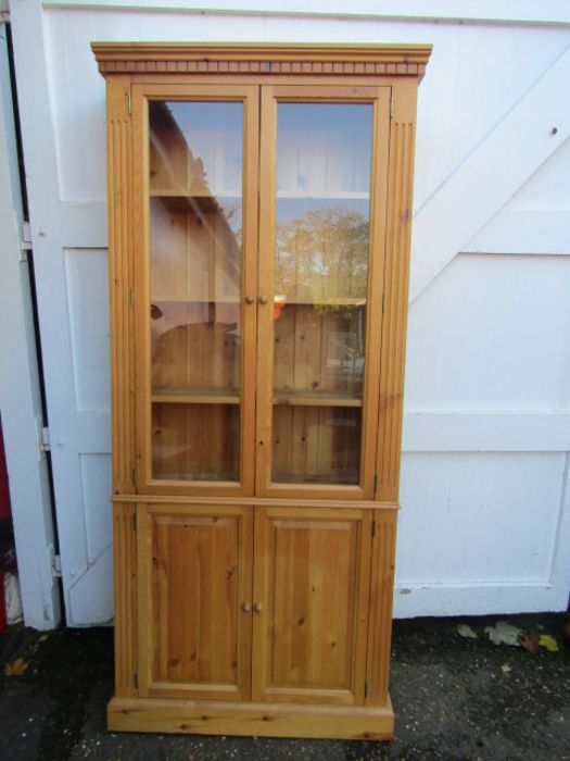 A pine bookcase with cupboard and glazed doors 200cmH 25cmD 89cmW