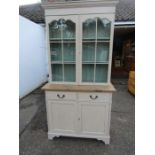 A painted glazed bookcase with key