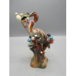 A Majolica flamingo hat pin holder with approx 20 vintage hat pins a/f