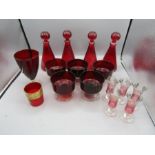 A collection of cranberry glass