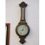 An oak wheel barometer with plaque