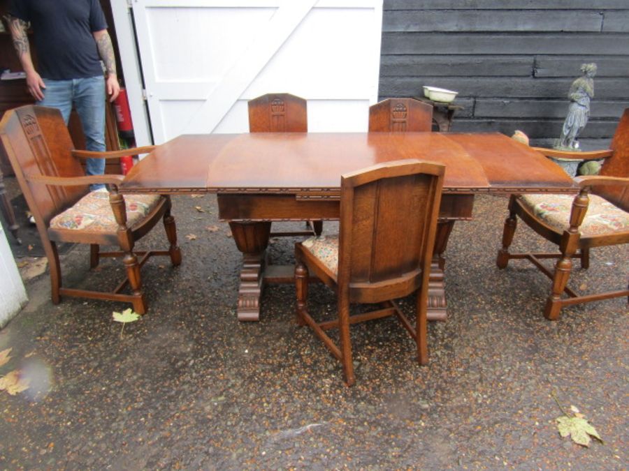 An Oak art deco style extending table and 5 chairs - 3 plus 2 carvers