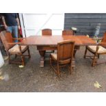 An Oak art deco style extending table and 5 chairs - 3 plus 2 carvers