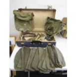 A suitcase containing German airforce hats -approx 15- 2 bags and few belts