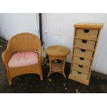 A pine storage unit with wicker drawers and a wicker table and chair
