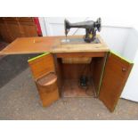 vintage singer sewing machine in cupboard