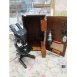 A Watson binocular microscope in original case with few accessories