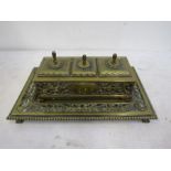 A decorative brass inkwell