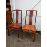 A pair of hardwood chairs