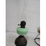 A green glass brass based oil lamp