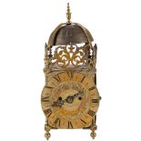 A brass lantern mantel clock: the eight-day duration double-fusee movement striking the hours on a