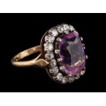 An amethyst and diamond ring,: the cushion shaped amethyst within a surround of old cut diamonds,