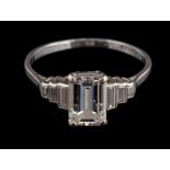 A platinum diamond ring,: the emerald cut diamond stated to weigh 1.