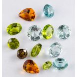 A group of unset gemstones,: including peridot; aquamarine; citrine; and others.