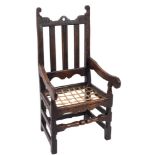 A late 17th Century oak open armchair:, the back with shaped top rail and pierced centre,