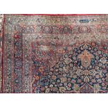 A Meshed carpet:, the indigo field with a central flowerhead pole medallion in red,