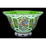 An overlay glass bowl: of flared form, in opaque white over a green stained ground,