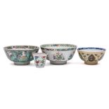 A group of three Chinese famille verte bowls and a teabowl: one with lotus medallion to the