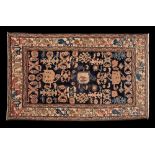 A Shirvan rug:, the indigo field with an all over design of hooked and boteh medallions,