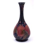 A William Moorcroft bottle vase: with slender waisted neck and flared rim,