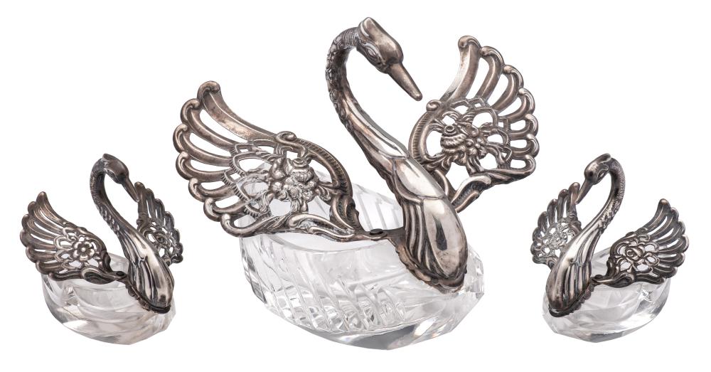 A pair of Continental white metal and cut glass salts : modelled as cygnets,