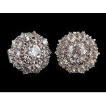 A pair of diamond cluster earrings,: the central old brilliant cut diamonds estimated to weigh 0.