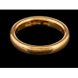A 22 carat gold ring,: the plain polished band, stamped 22 with full Birmingham hallmarks for 1920,