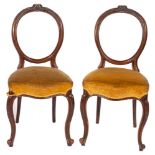 A set of six Victorian Pteridomania carved walnut and upholstered 'balloon back' dining chairs,