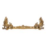 A 19th century gilt metal adjustable fire kerb in Louis XV style: with sliding adjustable foliate