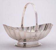 An Edward VII silver swing handled basket, maker Goldsmiths & silversmiths Co Ltd, London,