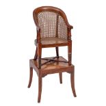 A child's early 19th Century mahogany bergere high chair:, on a stand,