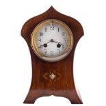 An Art Nouveau mahogany mantel clock: the eight-day duration movement striking the hours and
