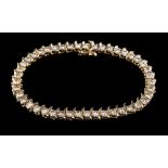 A diamond tennis bracelet,: set with a line of brilliant cut diamonds, approximately 7.