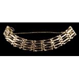 A gate link bracelet:, composed of polished panels, with a safety chain, missing clasp, 13.3g.